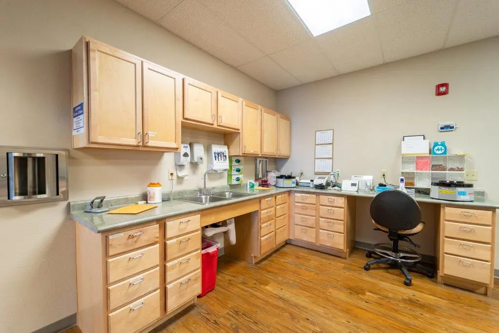 2719 Argent Ave-21-b233ed9 A kitchen with wooden cabinets and a desk.